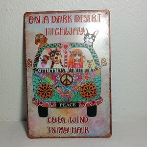 Sign that says On a Dark Desert Highway Cool Wind in My Hair